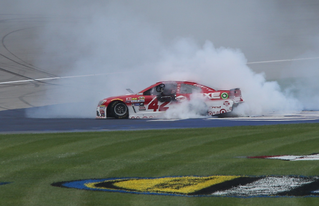 Kyle Larson duly burns some rubber in jubilation after his maiden Sprint Cup victory at Michigan