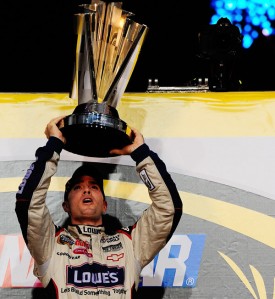 thumb Jimmie Johnson lifts his fourth-straight NASCAR Sprint Cup Series trophy in Homestead, Florida