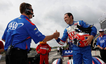thumb Helio Castroneves, right, celebrates his pole position with his Penske team