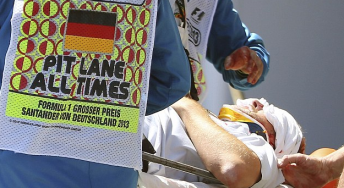 Paul Allen shortly after being struck by a flying wheel which came off Mark Webber's car. Pic: AP