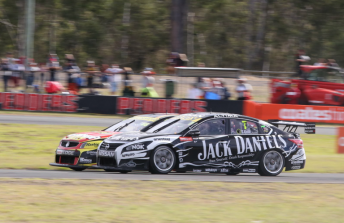 Todd Kelly hangs on around the outside of Russell Ingall at Queensland Raceway