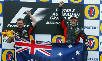 Mark Webber's magic moment alongside Minardi owner Paul Stoddart after finishing fifth at his F1 debut in 2002. After the podium ceremony was completed, race officials invited the pair up for a special celebration