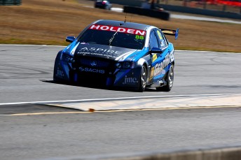 Paul Dumbrell boosted his title hopes with victory in chaotic Queensland Raceway opener