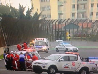 Webber on a stretcher giving the thumbs up to the Brazilian crowd